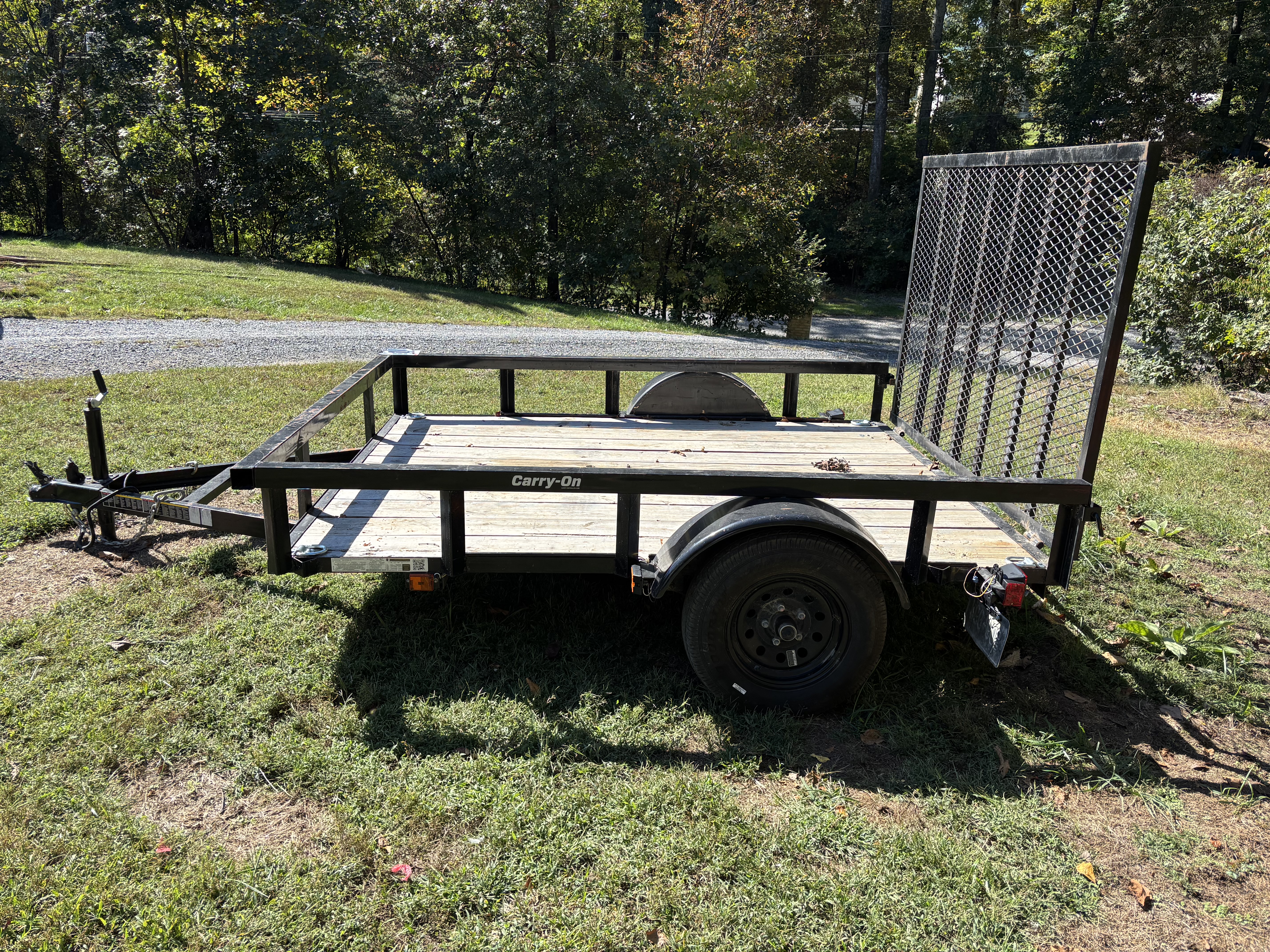 Carry-On utility trailer parked on grass